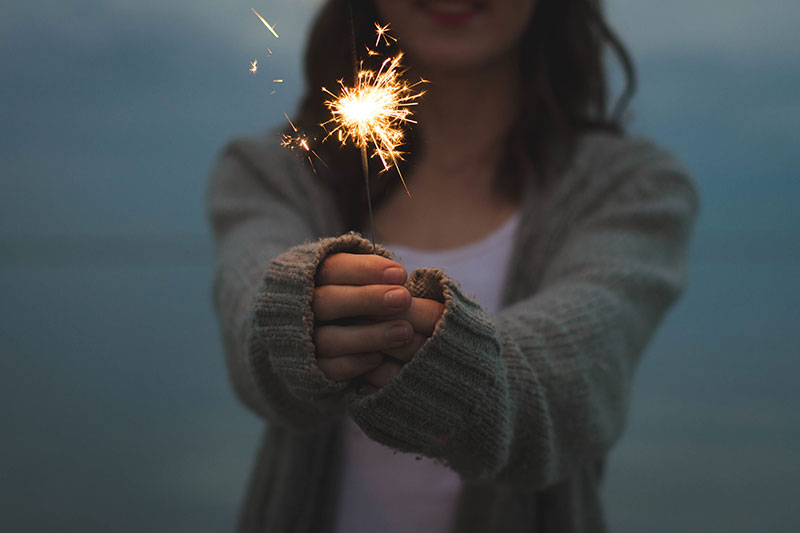 get financially fit. woman with sparkler.