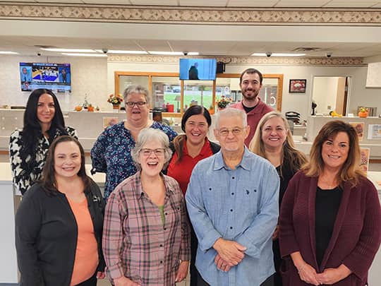 Friendly Buckeye State team members smiling together in a welcoming branch office.