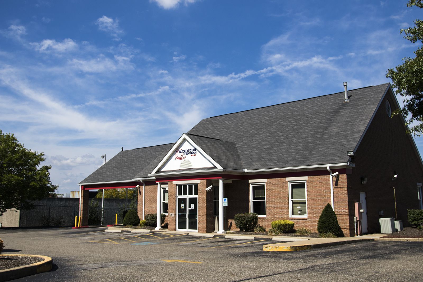 BSCU Akron Branch: Single-story brick building with parking lot, including accessible spaces.