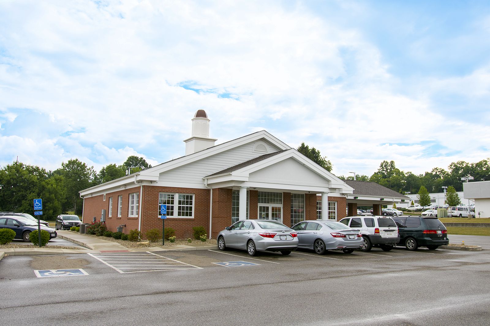 BSCU Alliance Branch: Brick building with accessible parking under clear sky.