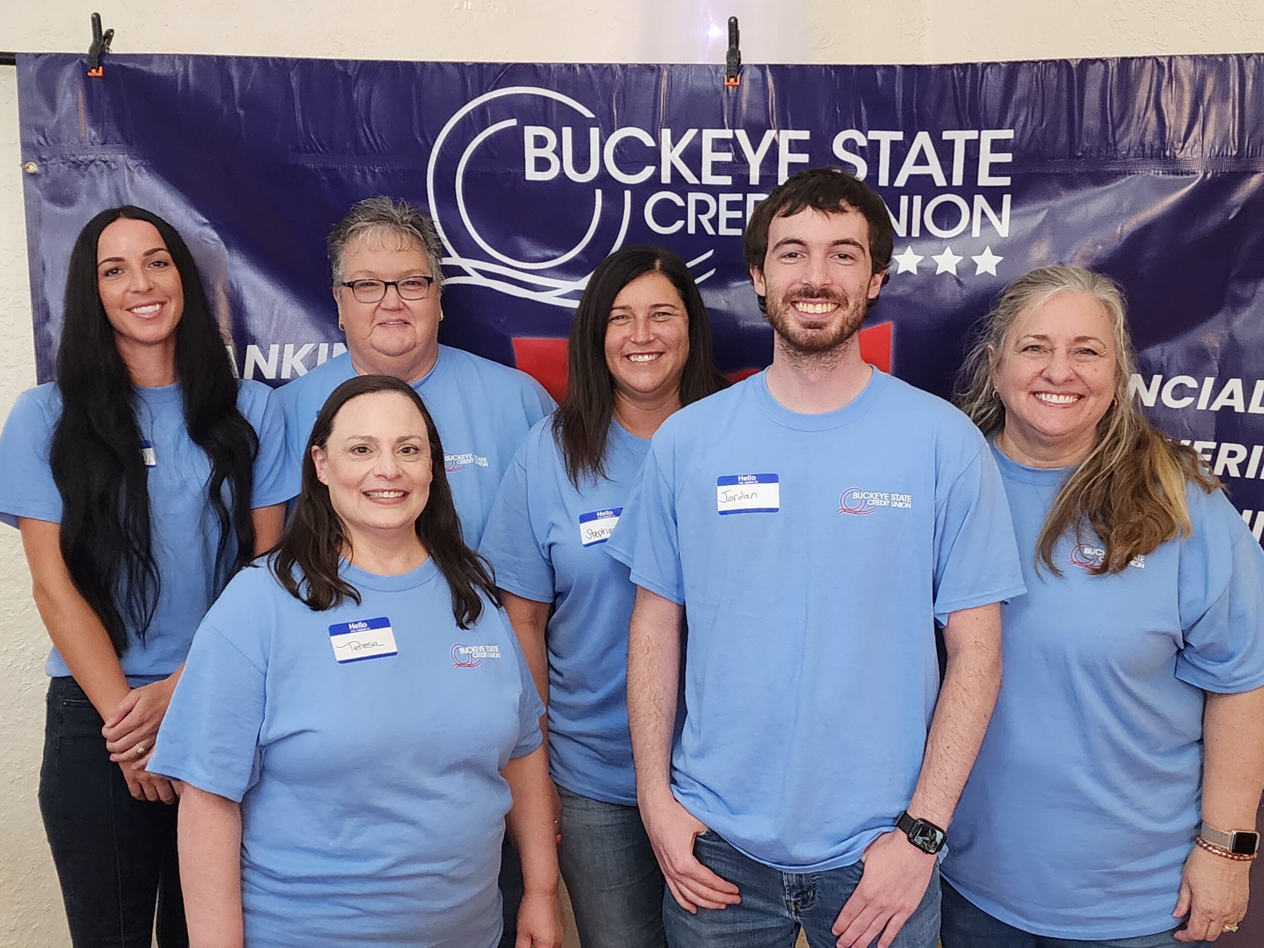 20230826_131236 Friendly Buckeye State team members smiling together in a welcoming branch office.